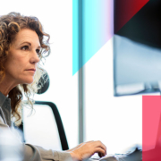 a woman is sitting in front of a computer monitor