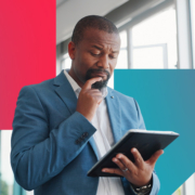 a man in a suit is looking at a tablet