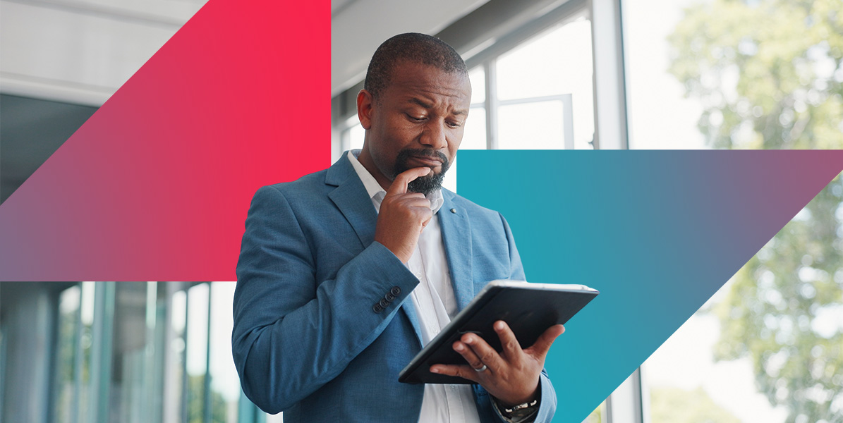 a man in a suit is looking at a tablet