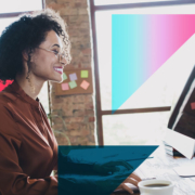 a woman is sitting at a desk in front of a computer