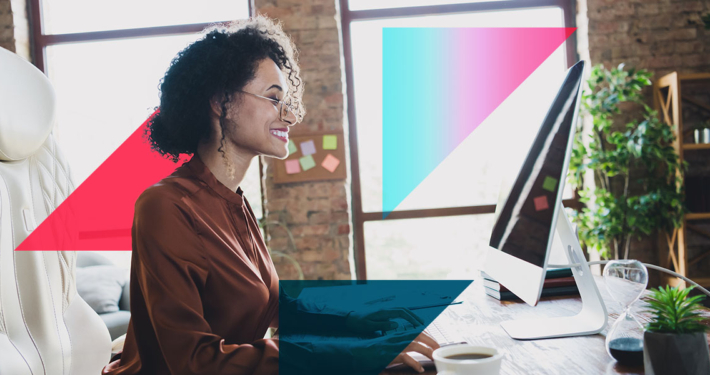 a woman is sitting at a desk in front of a computer