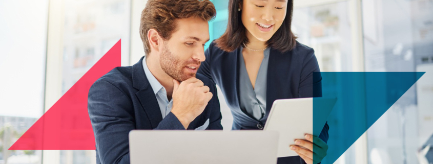 a man and a woman are looking at a laptop computer