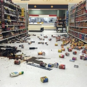 a blurred image of a store with a lot of trash on the floor